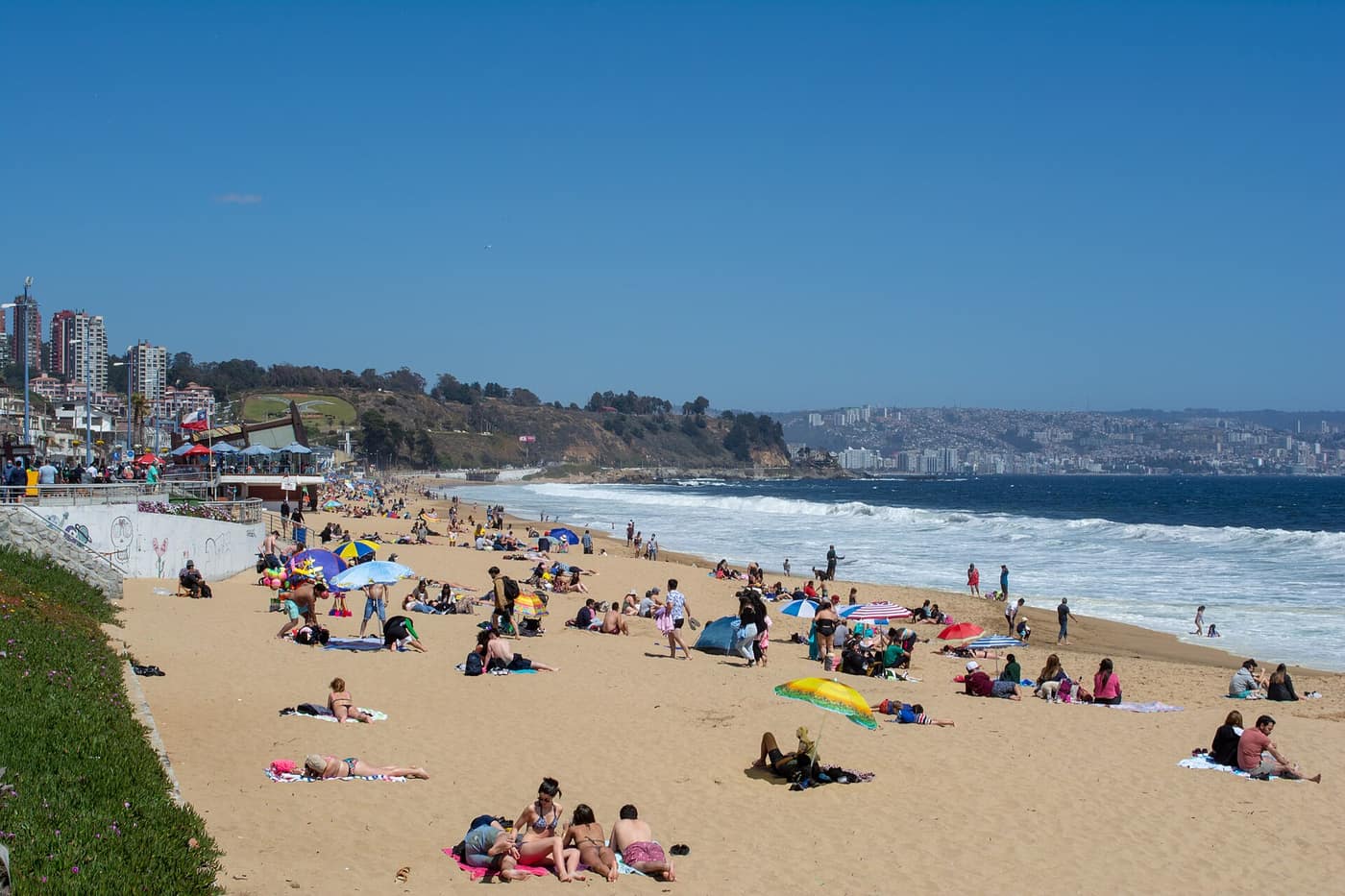 Sunbathers on the wide sandy beach of Reñaca, north of Viña del Mar, on a sunny day